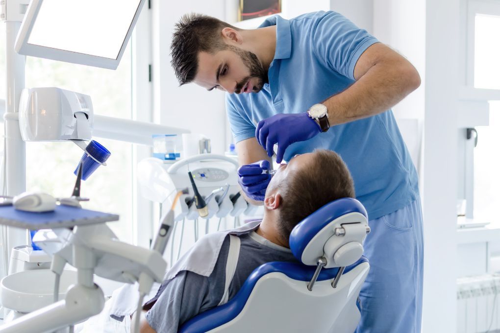 A dentist treating his patient